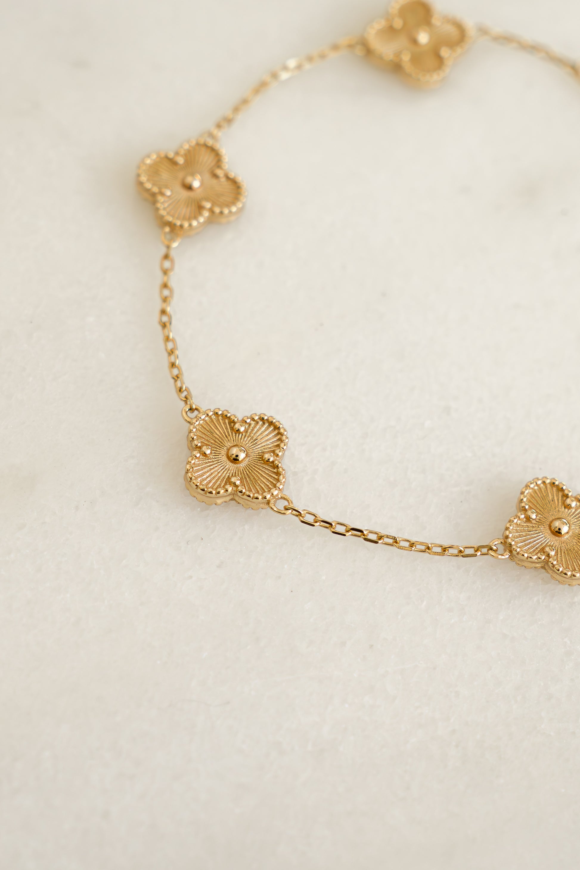 close up of the intricate details of the four leaf clover charm bracelet