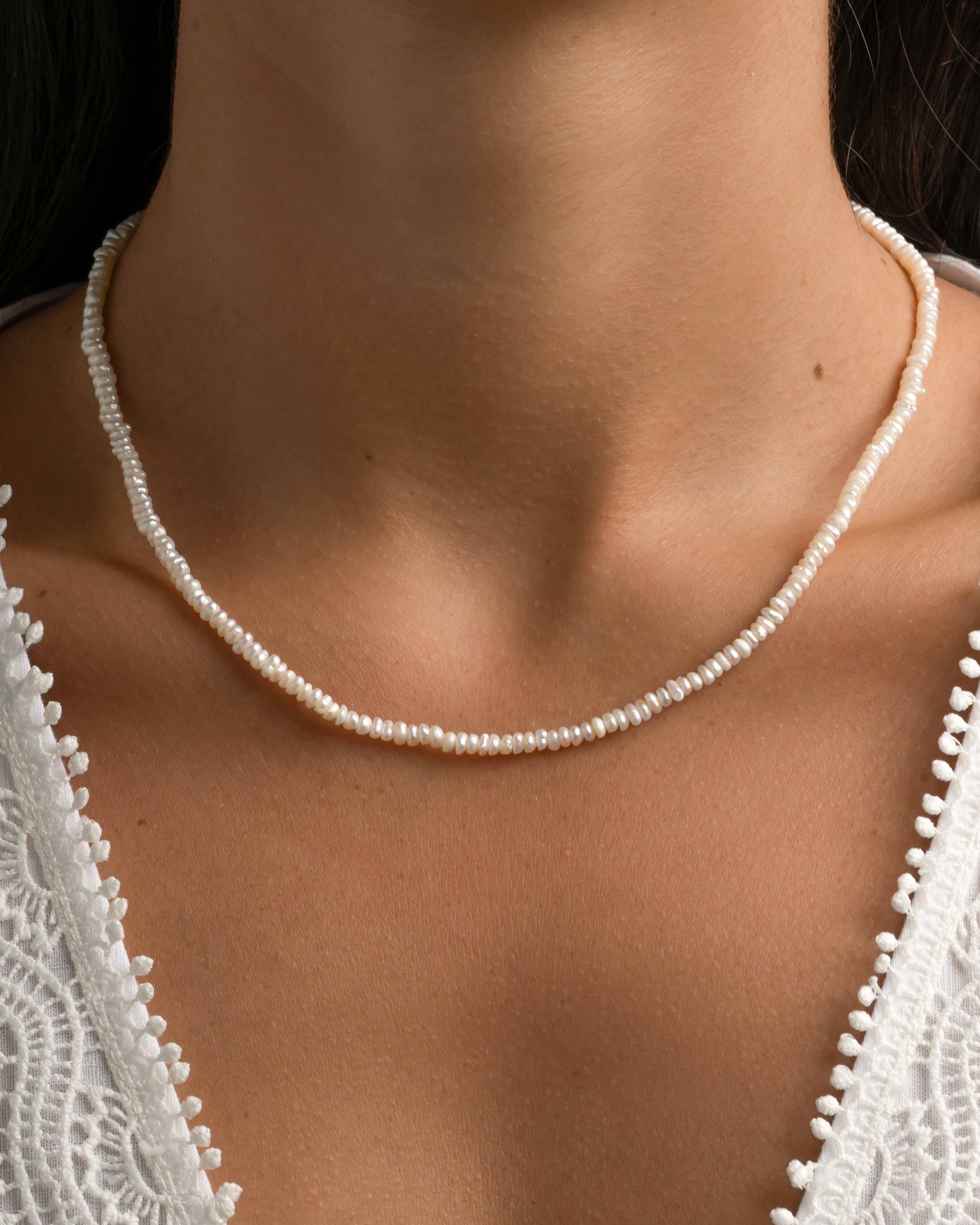Freshwater beaded pearl necklace by Sami Jewels featuring round white pearls on a delicate chain.