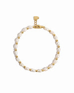 Freshwater pearl beaded bracelet by Sami Jewels featuring white pearls and gold accents on a neutral background.