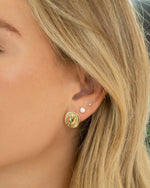 Gold freshwater pearl stud earrings by Sami Jewels, featuring smooth round pearls on classic post earrings.