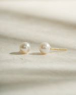 Gold freshwater pearl stud earrings by Sami Jewels featuring elegant, round pearl studs perfect for everyday wear.