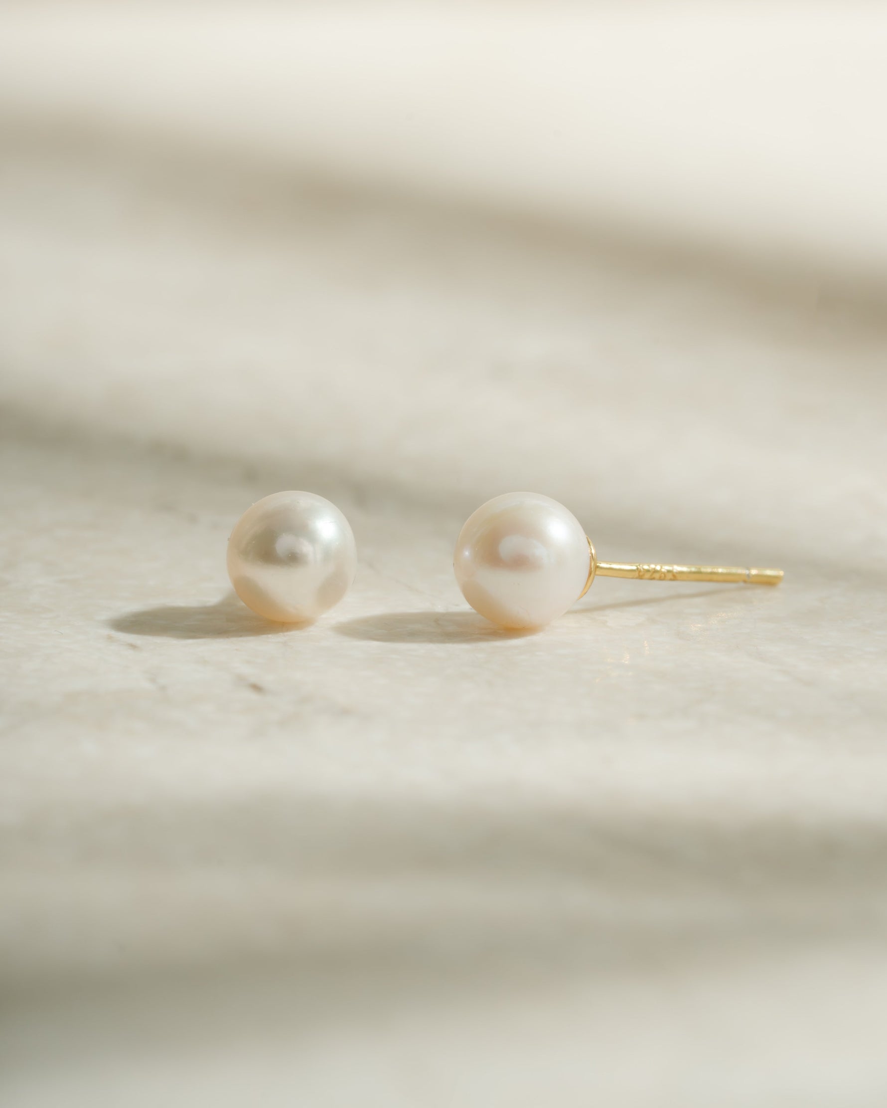 Gold freshwater pearl stud earrings by Sami Jewels featuring elegant, round pearl studs perfect for everyday wear.