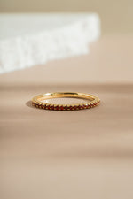 garnet birthstone eternity ring neutral background