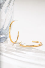 Close-up of gold stainless steel SS Geometric Hoops earrings by Sami Jewels, showcasing their modern geometric design.