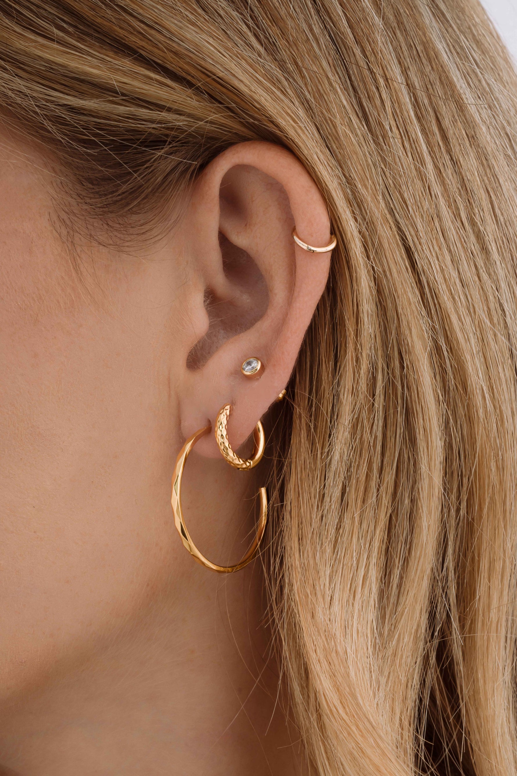 Gold stainless steel geometric hoop earrings by Sami Jewels, showcasing modern design and waterproof durability.