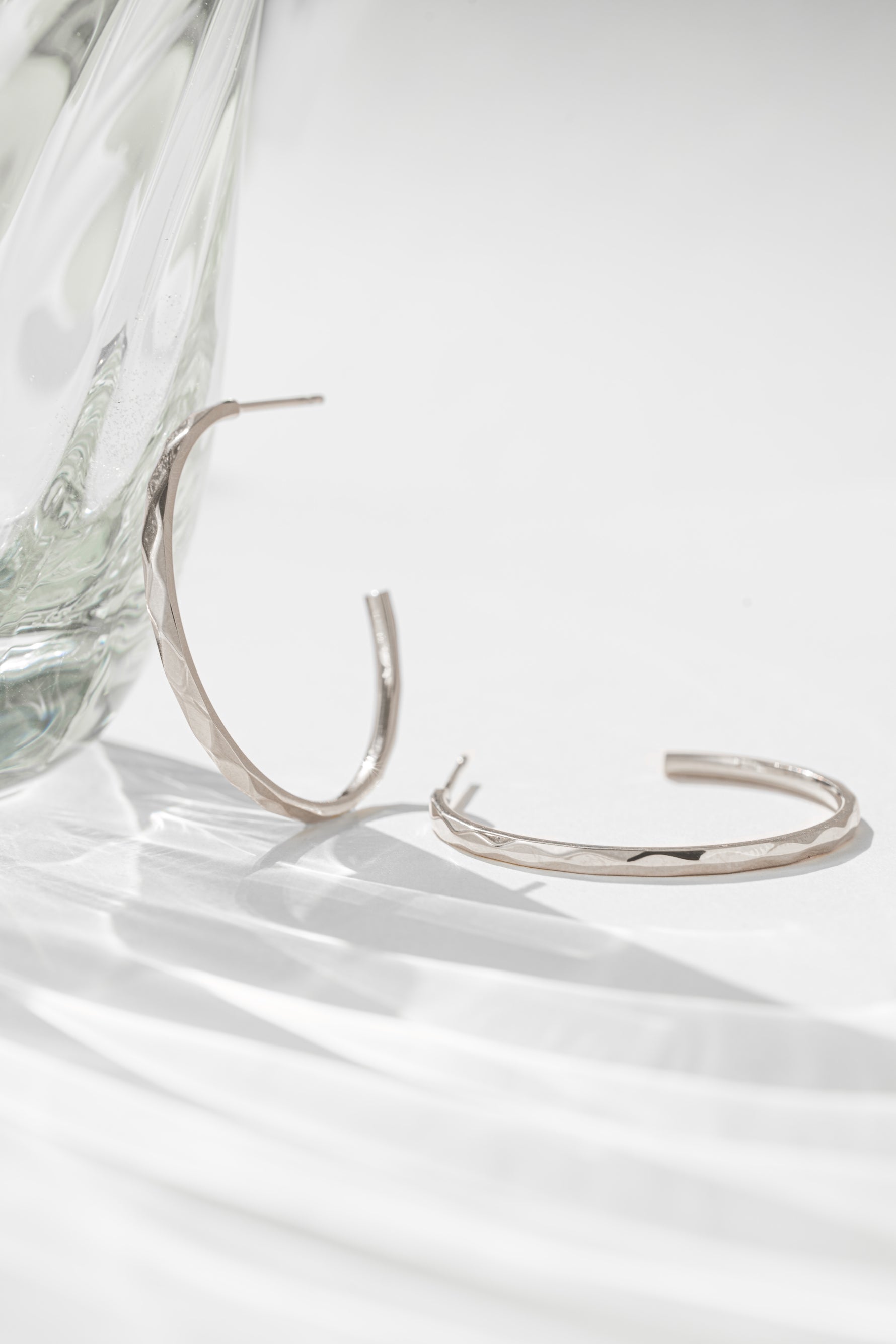 Close-up of silver stainless steel SS Geometric Hoops earrings by Sami Jewels, showcasing their modern geometric design.