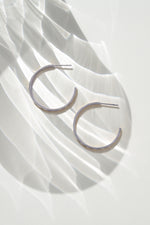 Silver stainless steel SS Geometric Hoops earrings with a modern design, shown from a side view. Durable and waterproof jewelry.