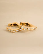 Close-up of gold geometric huggie earrings by Sami Jewels, showcasing their modern, angular design and polished finish.