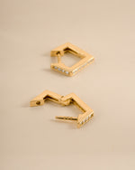 Gold geometric huggie earrings with latch-back closure from Sami Jewels, showcasing modern, minimalist jewelry design.
