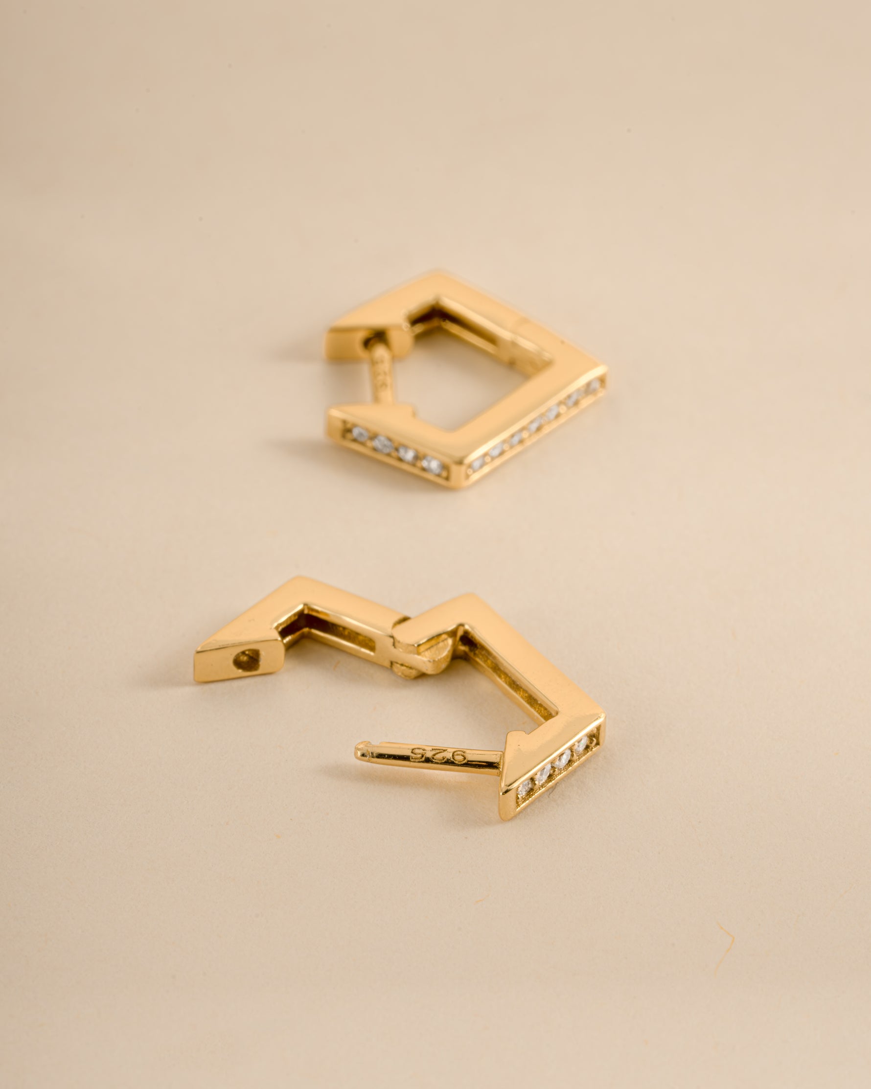 Gold geometric huggie earrings with latch-back closure from Sami Jewels, showcasing modern, minimalist jewelry design.