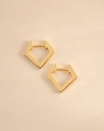 Gold geometric huggie earrings from Sami Jewels shown in side profile view, featuring modern angular design.