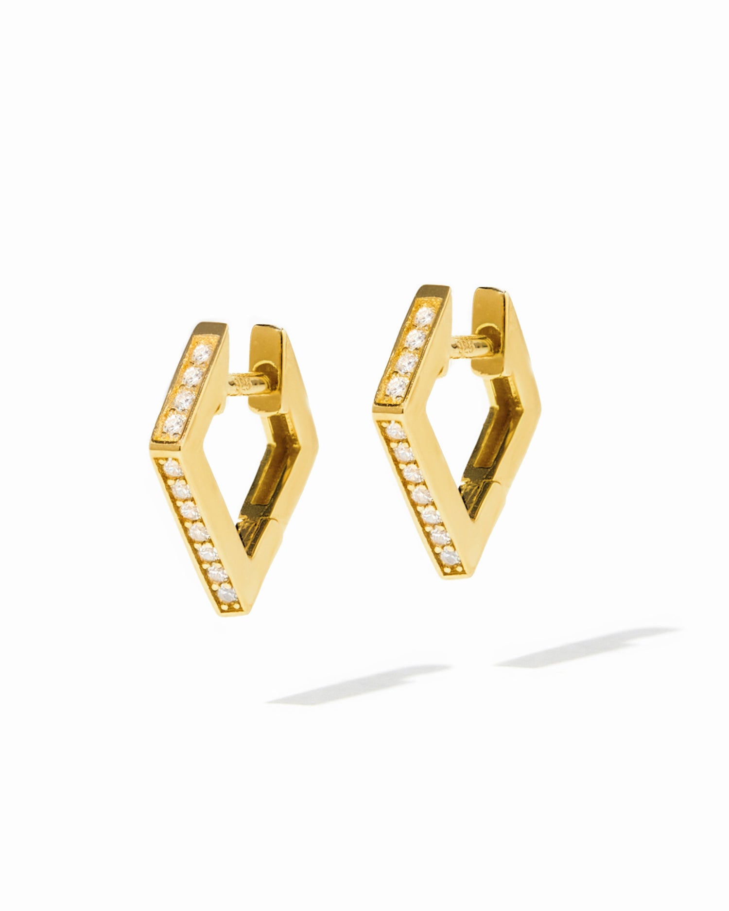 Gold geometric huggie earrings from Sami Jewels displayed on a white background.