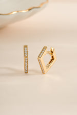 Gold geometric huggie earrings by Sami Jewels with sleek, modern design and secure hoop closure.