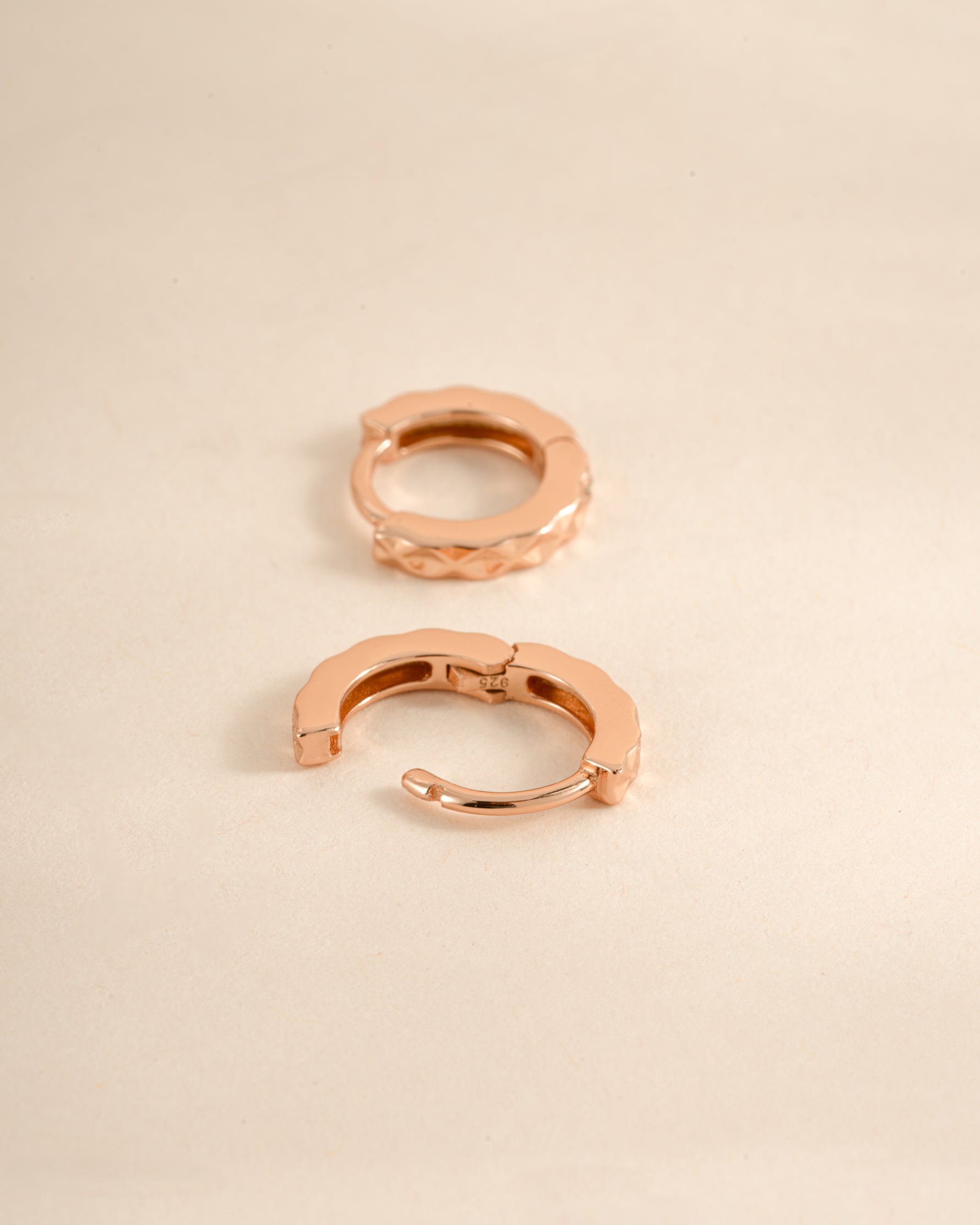 Rose gold geometric pattern huggie earrings by Sami Jewels with latch back closure, showcasing modern design and intricate details.