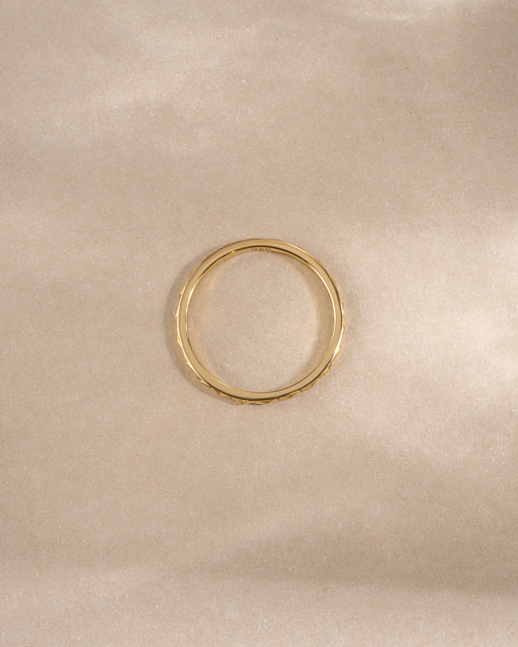 geometric stacking ring in gold on neutral background 