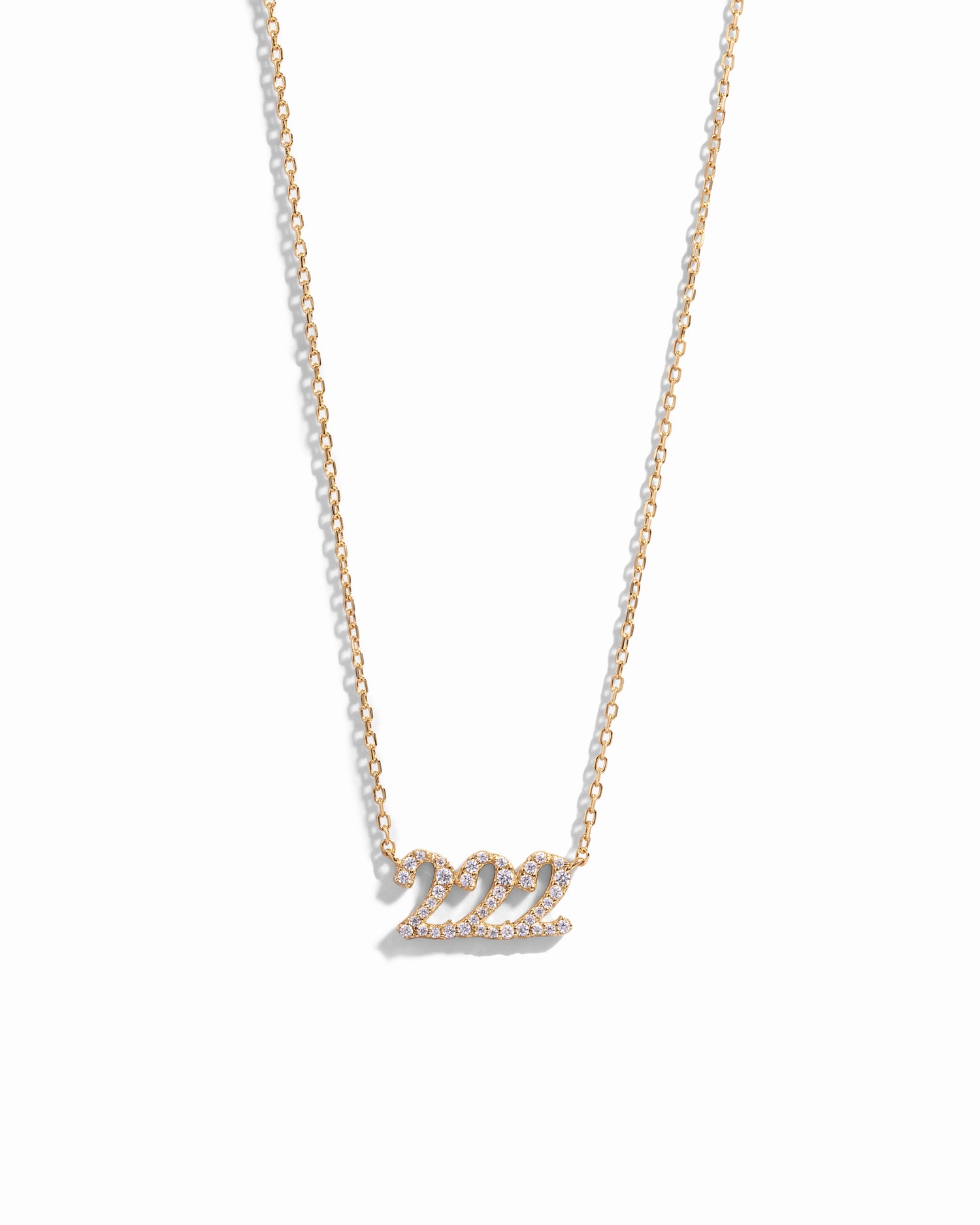 Gold necklace with angel number 222 pendant on a white background