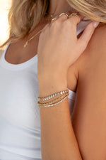 gold diamond round tennis bracelet on womens arm
