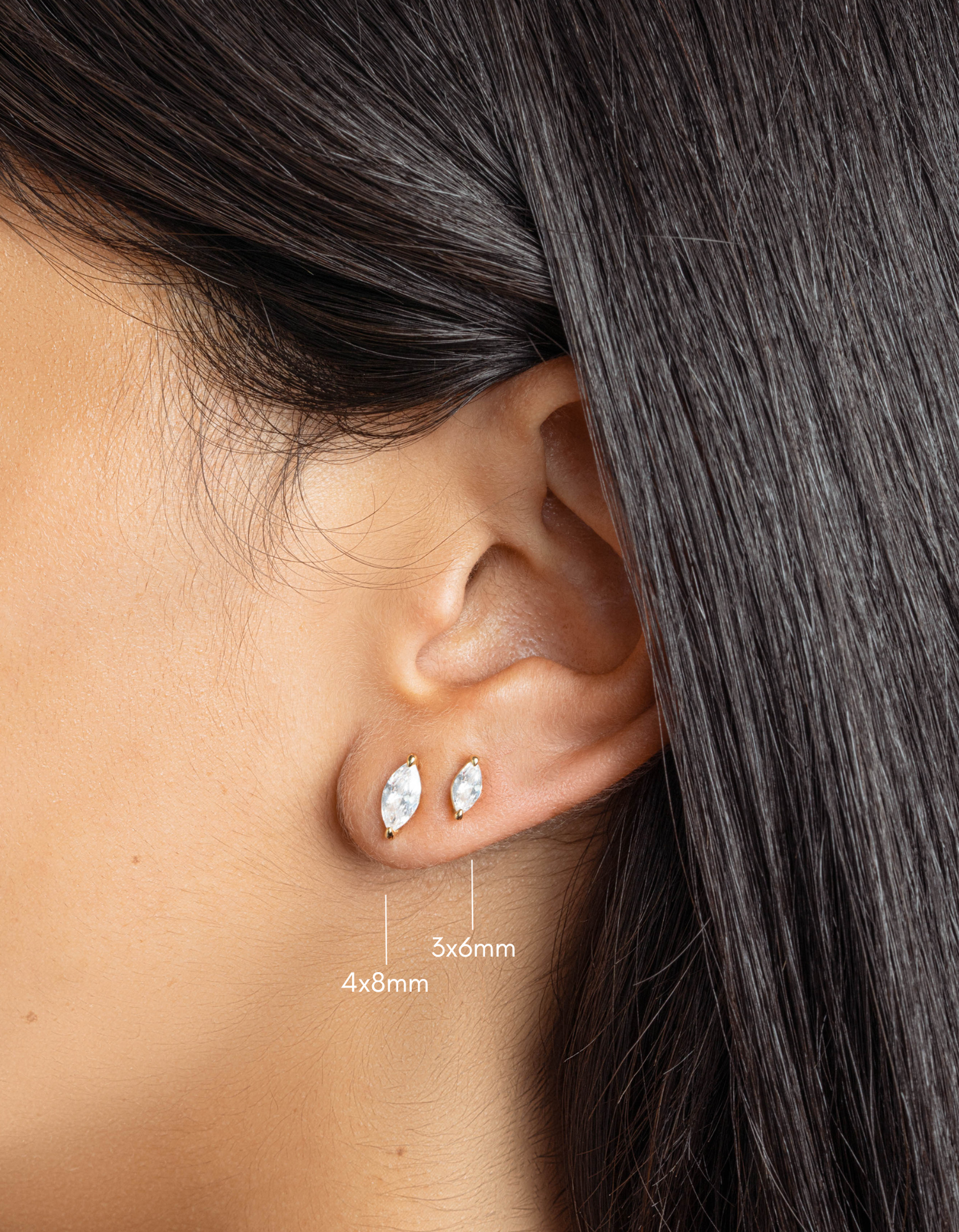 gold 4x8mm marquise cut stud earrings and 3x6mm marquise cut stud earrings on womens ear