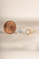 Gold 7.5mm round solitaire diamond stud earrings by Sami Jewels, showcasing sparkling single-diamond studs on a gold setting.