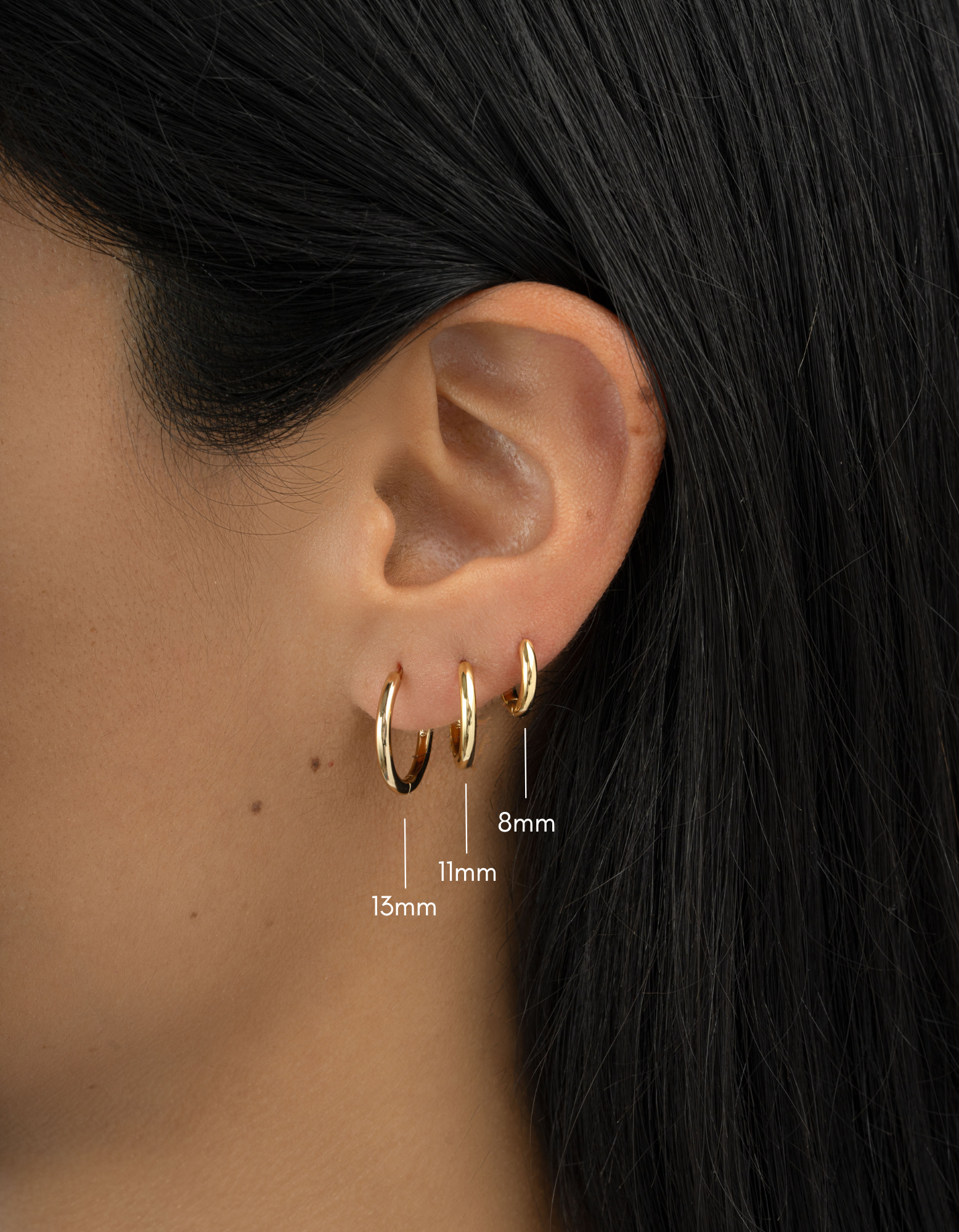 Gold 8mm minimalist hoop earrings set by Sami Jewels featuring three different-sized hoops on a model.