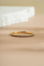 gold alexandrite eternity ring neutral background