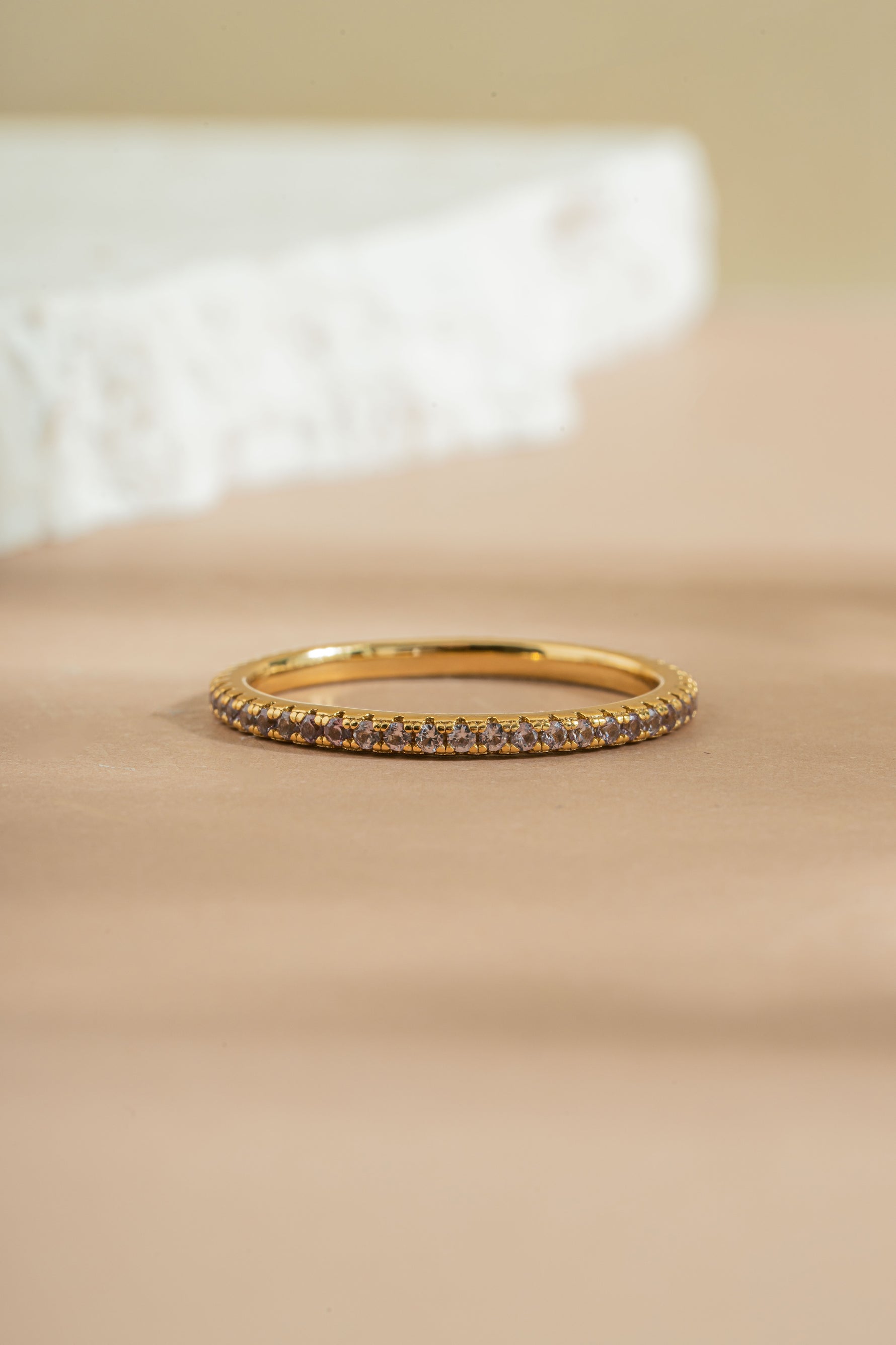 gold alexandrite eternity ring neutral background