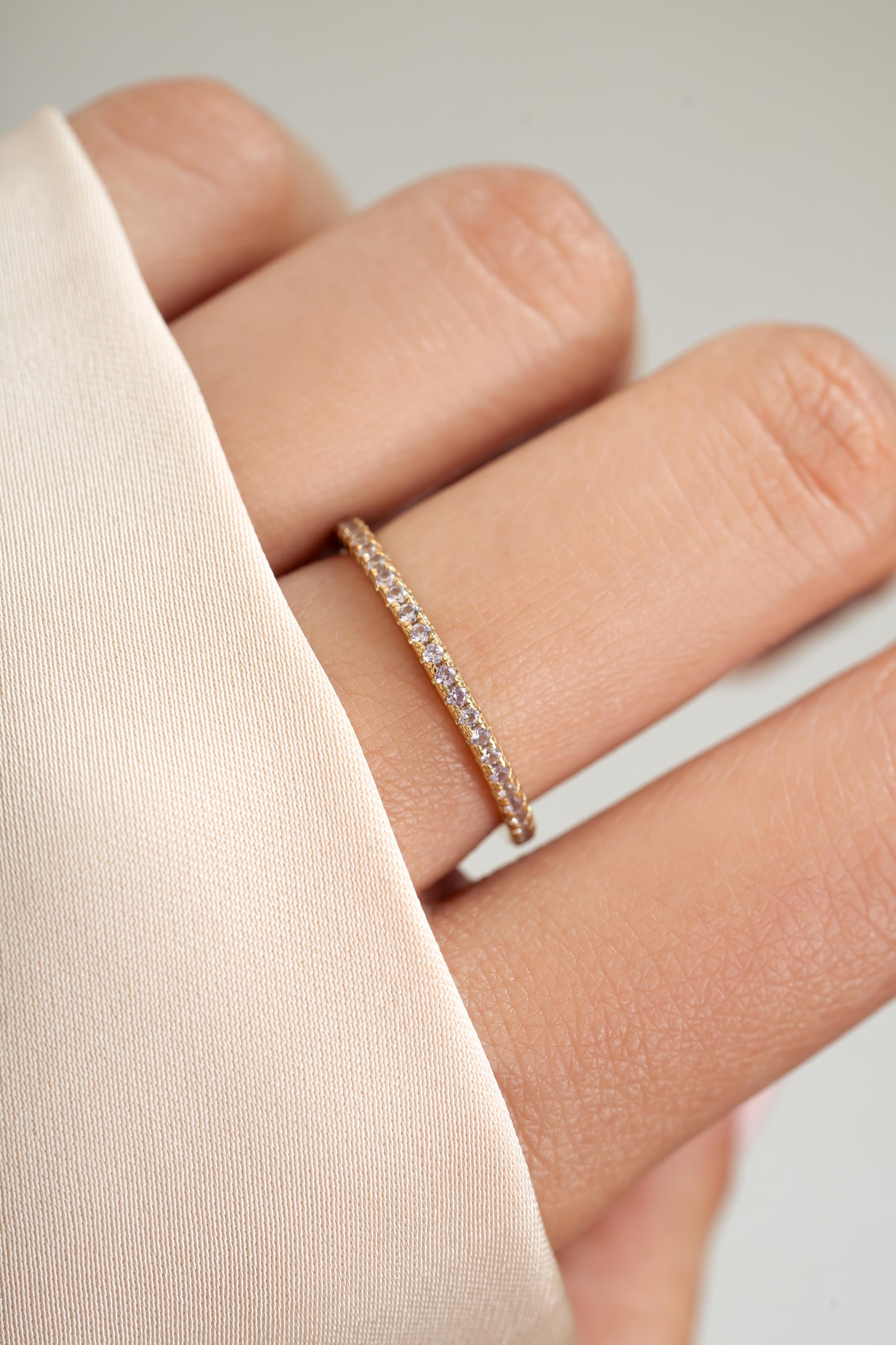 gold alexandrite eternity ring on womens hand 