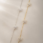 dainty diamond flower charms on delicate chain in 14k gold plated and sterling silver finishes.