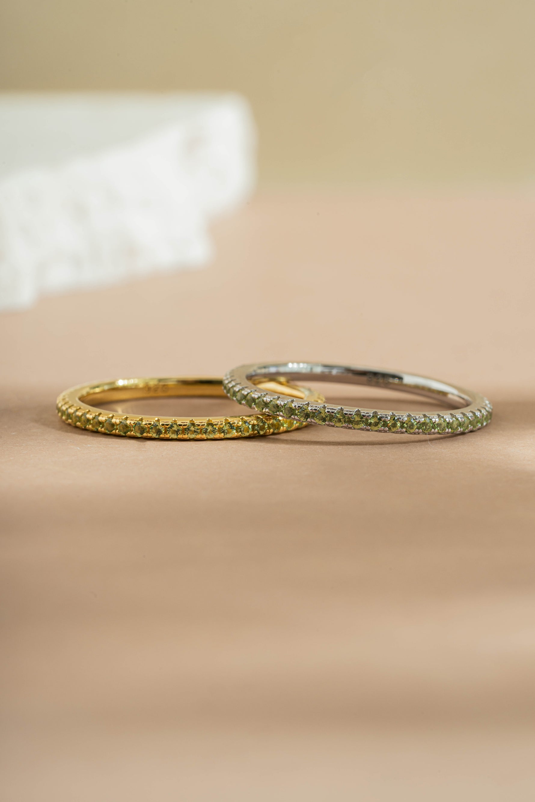 gold and sterling silver peridot birthstone eternity ring neutral background