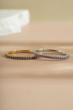 gold and sterling silver amethyst eternity ring neutral background
