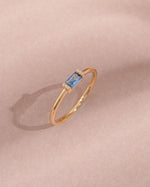 gold aquamarine baguette diamond ring close up view