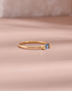 Gold aquamarine baguette ring with diamond accents, side view showcasing elegant design and gemstone details.