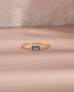 Gold aquamarine baguette ring with diamond accents, featuring a simple elegant design from Samijewels-527.