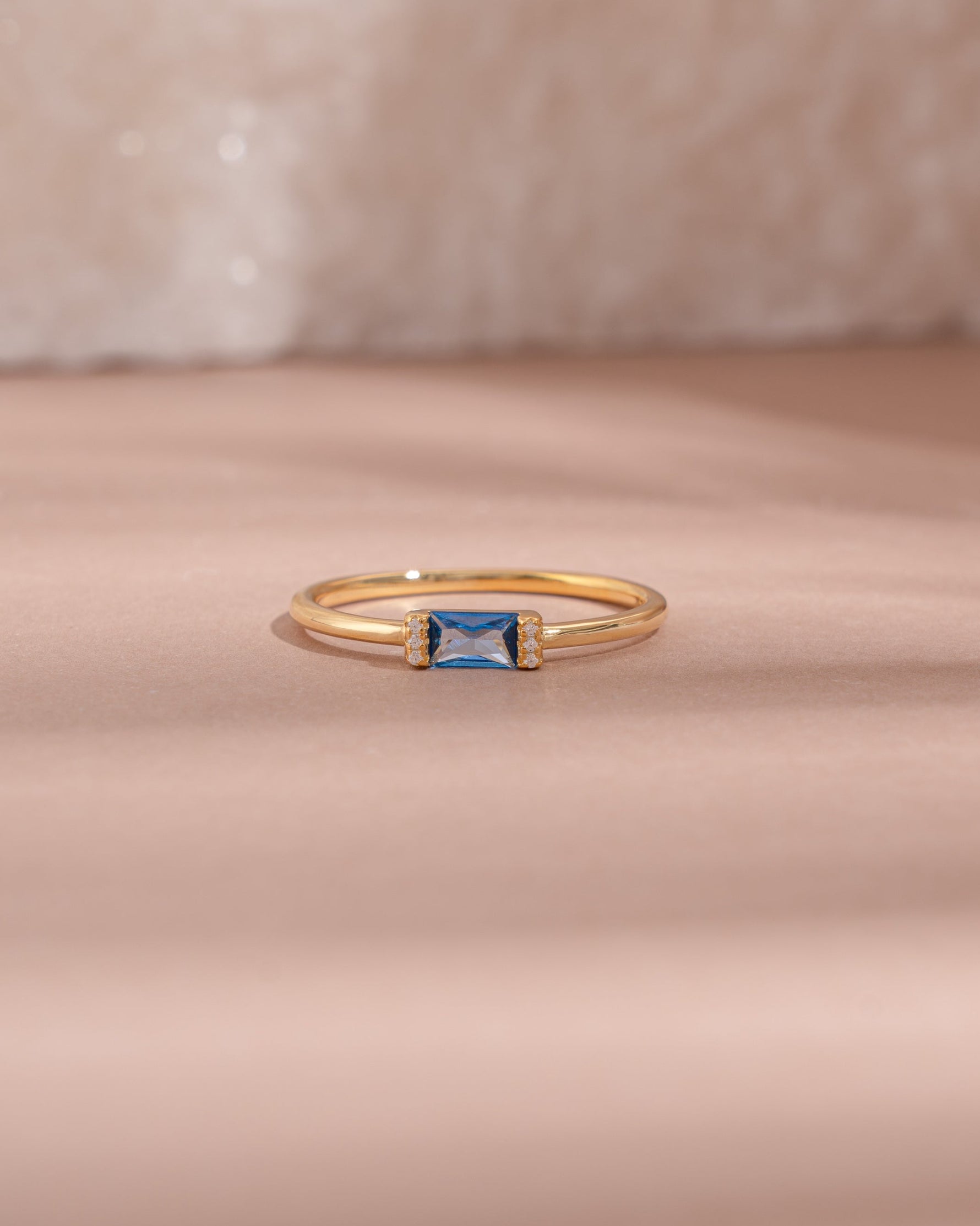 Gold aquamarine baguette ring with diamond accents, featuring a simple elegant design from Samijewels-527.