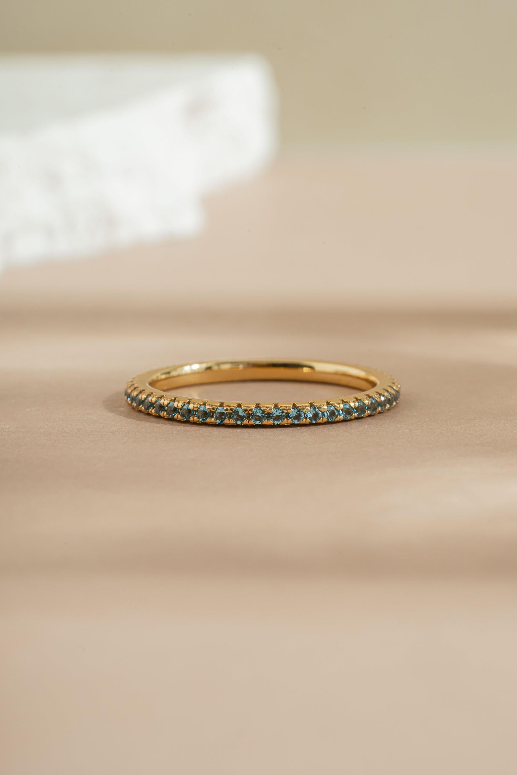 gold aquamarine birthstone eternity ring front view