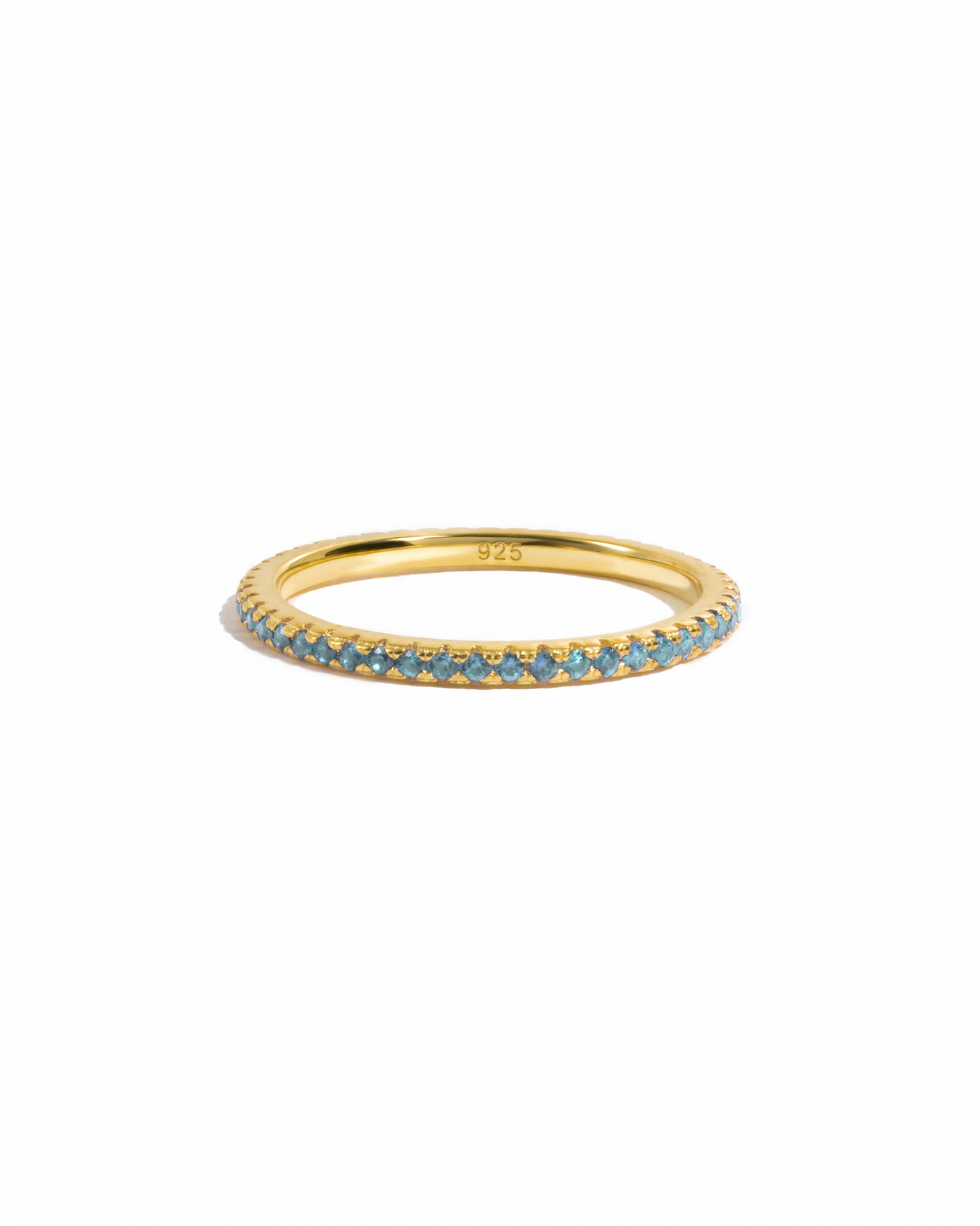 gold aquamarine birthstone eternity ring white background
