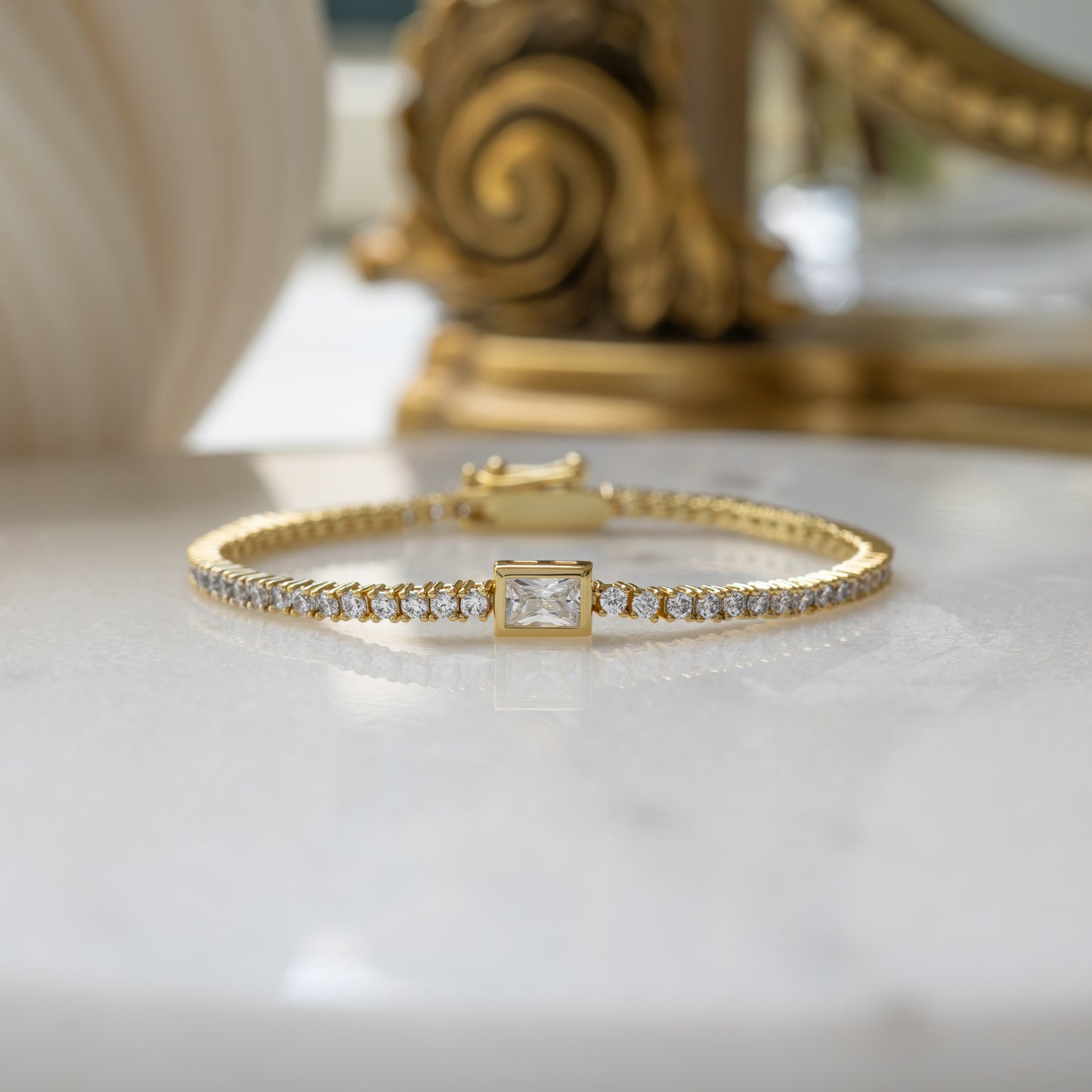 Gold Plated Bezeled Emerald-Cut Charm Tennis Bracelet on white background elegant gift from Sami Jewels