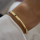 plain solid gold bangle on a wrist