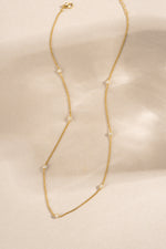 gold pave beaded necklace chain  neutral background
