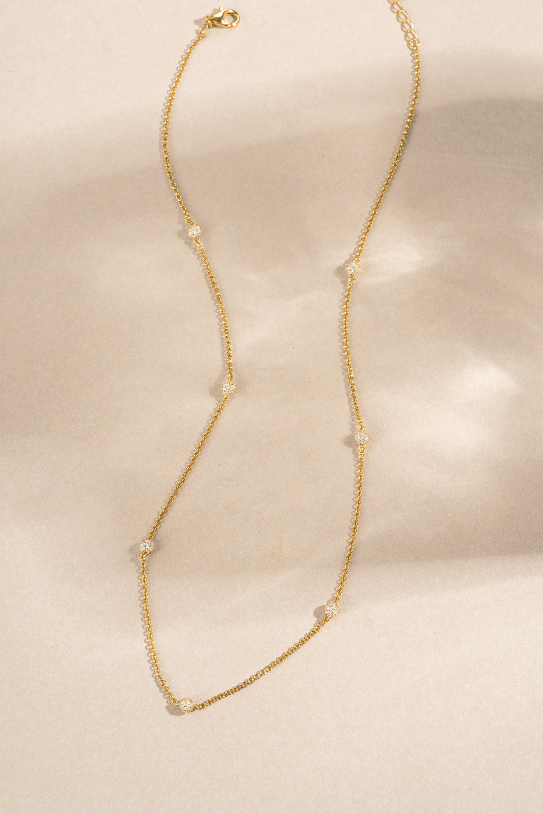 gold pave beaded necklace chain  neutral background