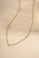 gold chain pave beaded necklace neutral background