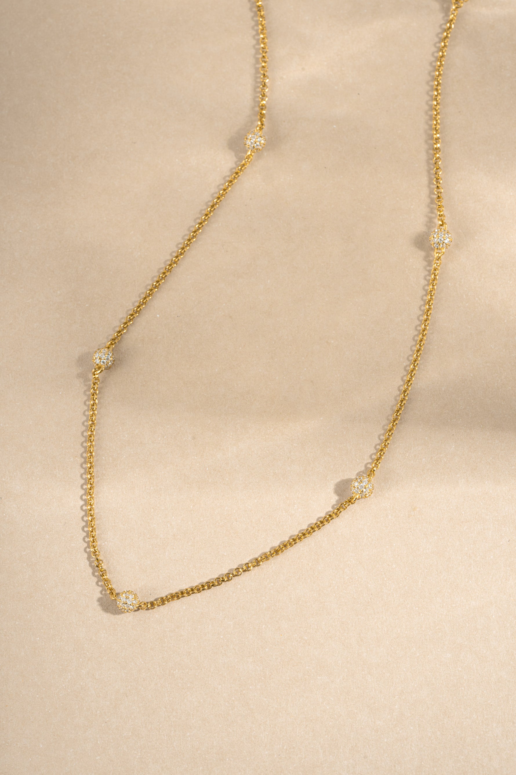 gold chain pave beaded necklace neutral background