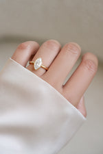 Gold bezel marquise ring by Sami Jewels displayed on a hand, showcasing its elegant design and craftsmanship.