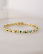 gold tennis bracelet with emerald green cubic zirconia stones