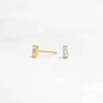 closeup image of minimalist gold earrings