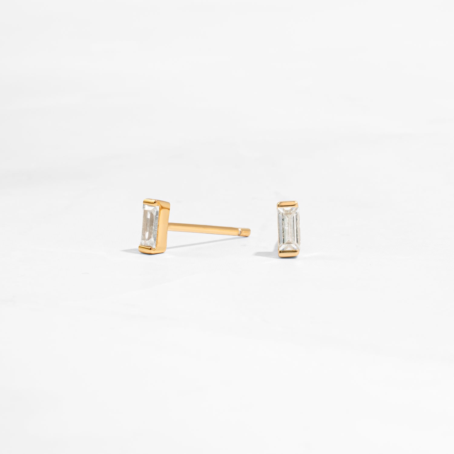 closeup image of minimalist gold earrings
