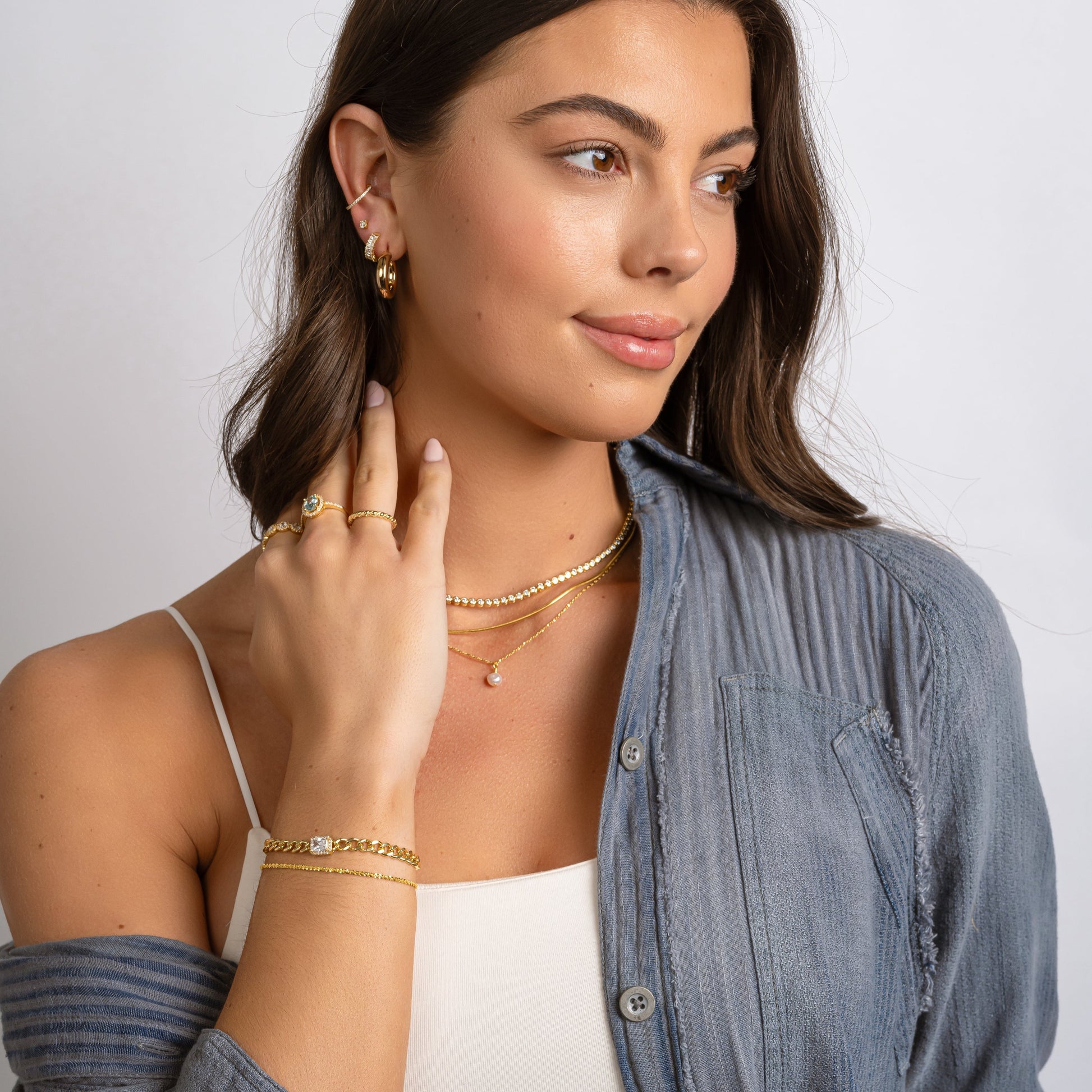 model wearing gold minimalist jewelry