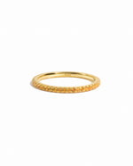 gold citrine birthstone eternity ring white background