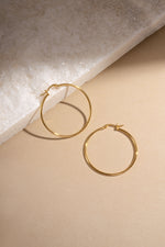 gold classic hoop earrings 40mm size neutral background