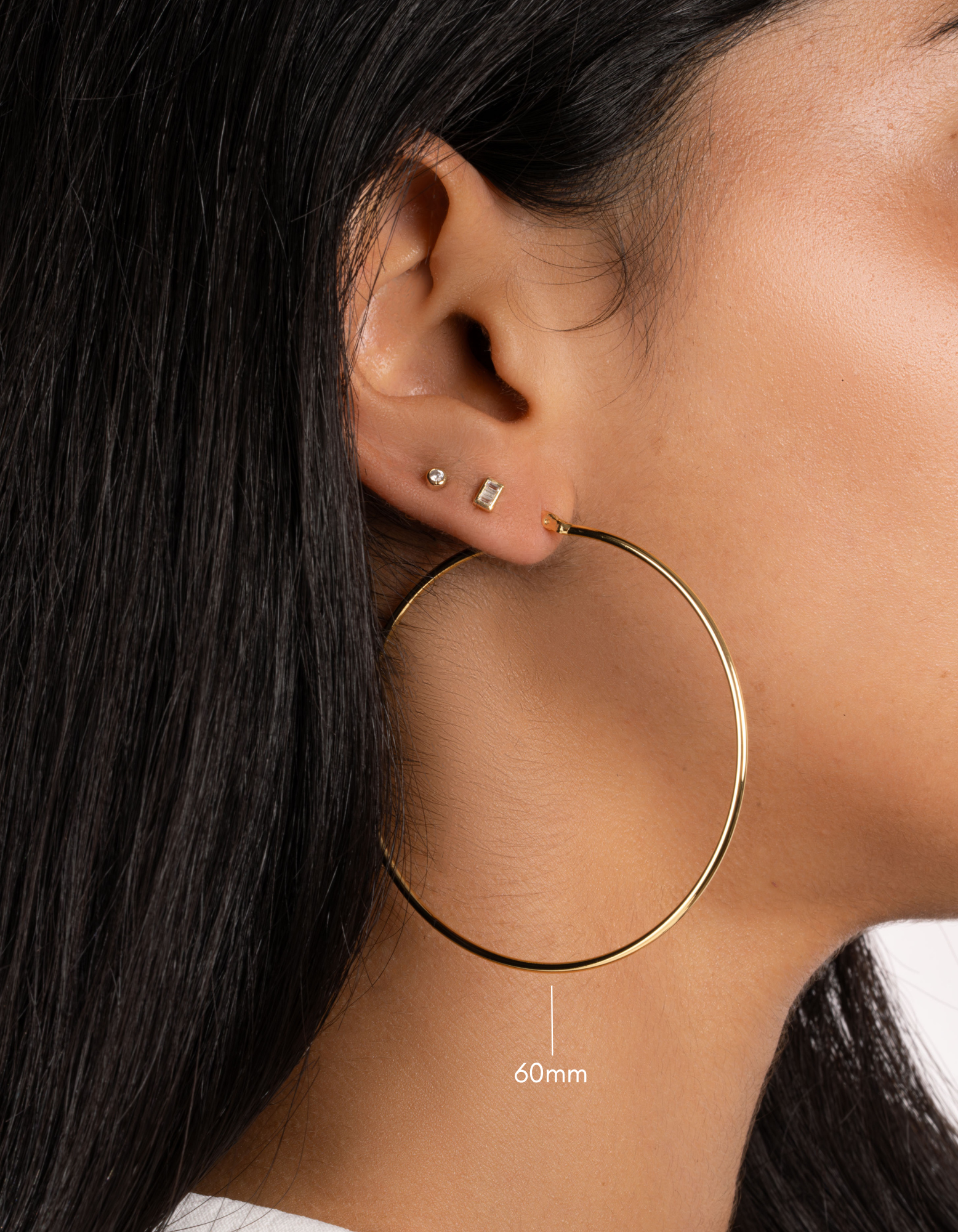 gold classic hoop earrings on model in 60mm size